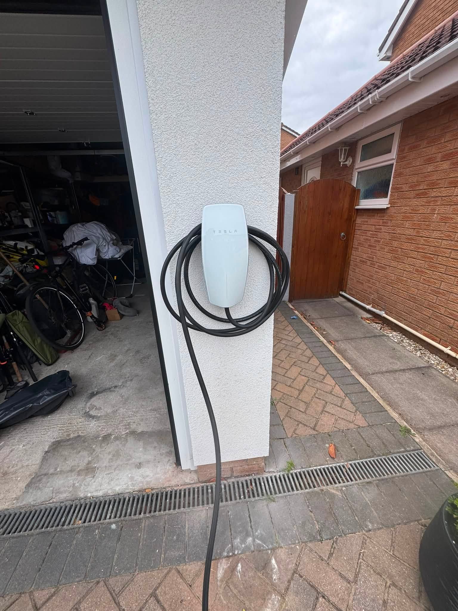 Wall-mounted electric vehicle charger on an exterior wall